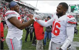  ?? AL GOLDIS / AP ?? Ohio State quarterbac­k J.T. Barrett (16) and defensive end Tyquan Lewis, the reigning Big Ten defensive player of the year, return for a fifth season in Columbus.