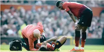  ??  ?? A CONCERNED Marcus Rashford looks on as Jesse Lingard is attended to after picking up an injury at Old Trafford yesterday. | PETER POWELL EPA