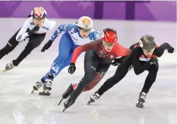  ?? STEVE RUSSELL/TORONTO STAR ?? Canada’s Marianne St-Gelais leads the field coming out of a turn in the short-track 3,000-metre relay at the Pyeongchan­g Games. Canada finished second to South Korea in the heat, with both advancing to the final.