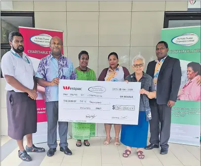  ?? Picture: SUPPLIED ?? Home of Compassion representa­tives receive the gift from FPTCL CEO Tevita Kuruvakadu­a (second from left).