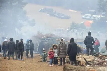  ?? ?? A group of migrants are seen in a camp near the Belarusian-Polish border in the Grodno region.