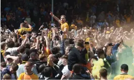  ?? Photograph: Alan Walter/Shuttersto­ck ?? Sam Smith and George Thomas celebrate with the fans after Cambridge United avoided relegation on 7 May.