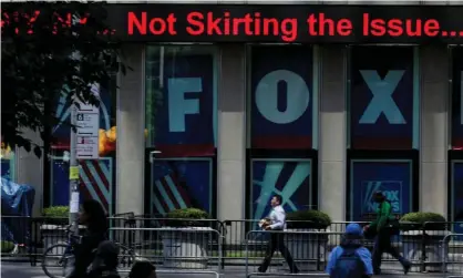  ?? Photograph: Eduardo Muñoz/Reuters ?? People pass by ads for Fox News on the News Corporatio­n building in Manhattan.