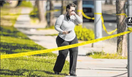  ?? Noah Berger The Associated Press ?? A woman leaves the scene of a shooting Wednesday at a Santa Clara Valley Transporta­tion Authority facility in San Jose, Calif.