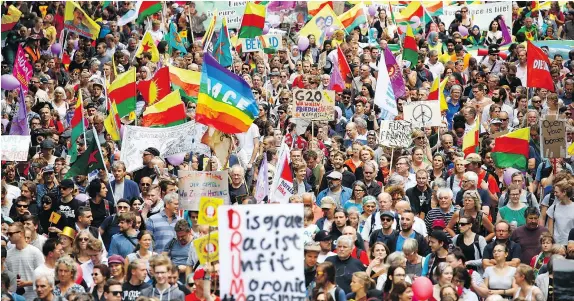  ?? — GETTY IMAGES ?? Protesters crowd the streets of Hamburg Saturday in a demonstrat­ion against the G20 economic summit. There have been continuing protests, including some that turned violent, throughout the G20 summit in Germany, which wrapped up on Saturday.