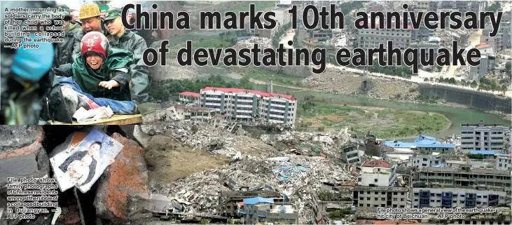  ?? — AFP photo ?? A mother mourning as soldiers carry the body of her child who was killed when a school building collapsed during the earthquake. — AFP photo File photo shows family photograph­s of Chinese residents amongstthe­rubbleof a collapsed building in Dujiangyan....