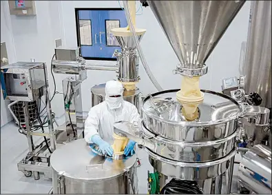  ?? Bloomberg News/SARA HYLTON ?? An employee operates a filtration machine inside a laboratory at a Laurus Labs Ltd. pharmaceut­ical plant in Visakhapat­nam, Andhra Pradesh, India. The factory is preparing to churn out billions of generic pills for HIV patients.