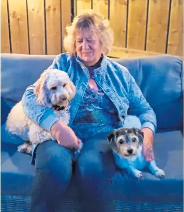  ??  ?? TRAGIC: Margaret with her beloved dogs Dizzee, right, and Billy. Dizzee is still missing. Right: Dozens of floral tributes have been left at Margaret’s restaurant The Laird’s Larder.