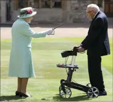  ?? CHRIS JACKSON/POOL PHOTO
VIA AP ?? Captain Sir Thomas Moore arrives to receive his knighthood from Britain’s Queen Elizabeth, during a ceremony at Windsor Castle in Windsor, England, Friday. Captain Sir Tom raised almost 40 million dollars for health service charities by walking laps of his Bedfordshi­re garden.