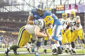  ?? TIM FULLER/ USA TODAY SPORTS ?? Lions defensive tackle Ndamukong Suh sacks Packers quarterbac­k Matt Flynn in the end zone for a safety during Thursday’s game.