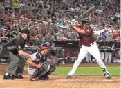  ??  ?? J.D. Martinez bats during the seventh inning against the Washington Nationals on Sunday at Chase Field.