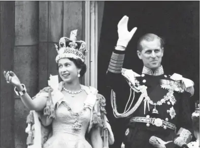  ?? PA Photos / TNS ?? Queen Elizabeth II wears the Imperial State Crown and the Duke of Edinburgh the uniform of Admiral of the Fleet as they wave from the balcony to the onlooking crowds around Buckingham Palace after the Coronation on June 2, 1953.