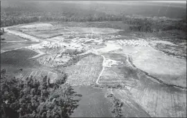  ??  ?? KOHL KEEPS a 1978 aerial photo of Jonestown, Guyana. “Look how much we accomplish­ed in just two years,” she says of the compound she helped to establish.