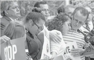  ?? Marie D. De Jesús / Houston Chronicle ?? Juan Rodriguez, right, holds his daughter Karen during a news conference Monday in front of the federal courthouse. Karen said she was encouraged by all of the help the family has received.