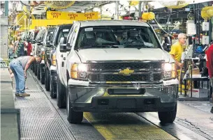  ?? CARLOS OSORIO THE ASSOCIATED PRESS ?? Union documents show that at Flint, where GM builds its heavy-duty pickups, 255 temps became permanent. At Lansing Delta Township, where GM builds its midsize SUVS, it hired 103 temps.