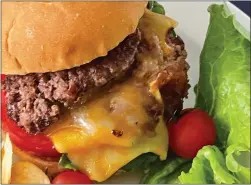  ?? PHOTO BY CATHY THOMAS ?? Smash Cheeseburg­ers are quick and easy to make for the Fourth of July or any summer cookout. Two patties and a toasted bun add to the flavorful treat.