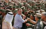  ?? AP PHOTO/J. SCOTT APPLEWHITE, FILE ?? In this Nov. 22, 1990 file photo, President George H.W. Bush is greeted by Saudi troops and others as he arrives in Dhahran, Saudi Arabia, for a Thanksgivi­ng visit.