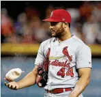  ?? ROSS D. FRANKLIN / AP 2019 ?? Cardinals reliever Junior Fernandez flips the rosin bag during a game last season. Due to the pandemic, pitchers will have to use their own rosin bags when the shortened season begins next month.