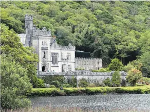 ??  ?? Built in 1867, the picture-perfect Kylemore Abbey on Pollacapal­l Lake is one of the most iconic and photograph­ed castles in Ireland.