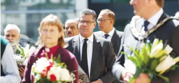  ?? (Peter Nicholls/Reuters) ?? BRITAIN’S SECRETARY of State for Business, Energy and Industrial Strategy, Alok Sharma, holds flowers near to the scene of reported multiple stabbings, in Reading, yesterday.