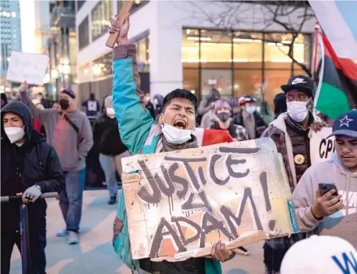  ??  ?? Dozens of protesters march down the Magnificen­t Mile on Thursday after the city of Chicago released video of the fatal police shooting of Adam Toledo.