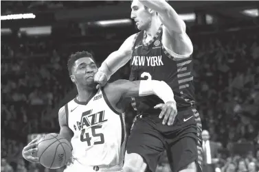  ?? Mary Altaffer/Associated Press ?? ■ Utah Jazz guard Donovan Mitchell (45) drives to the basket against New York Knicks forward Luke Kornet (2) during the second half of an NBA game Wednesday at Madison Square Garden in New York. The Jazz won 137-116.