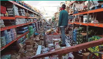  ?? REUTERS PIC ?? A man standing in a supermarke­t destroyed by Hurricane Maria in Salinas, Puerto Rico, on Friday.