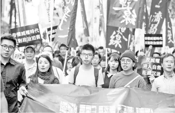  ??  ?? Wong (centre) leads a protest in Hong Kong. — AFP photo