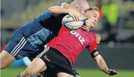  ?? Picture: GETTY IMAGES ?? SHAKEDOWN: Andy Ellis of the Crusaders is tackled by Tony Woodcock of the Blues during their clash in Christchur­ch, New Zealand, yesterday