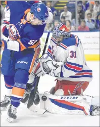  ?? CP PHOTO ?? New York Rangers goalie Ondrej Pavelec, right, of the Czech Republic, stops a shot attempt by New York Islanders’ Ross Johnston, left, in this file photo from pre-season play last September. Screaming Eagles fans have fond memories of Pavelec, who...