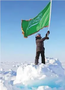  ??  ?? ■ Mariam Fardous displays the Saudi flag at the North Pole. She embarked on her trip on March 28, 2016.