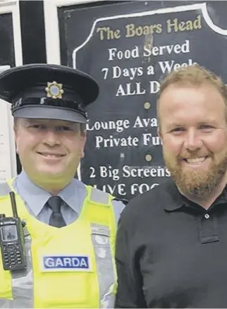  ??  ?? 0 Open champion Shane Lowry is greeted by the Garda in Dublin yesterday as he brought the Claret Jug to the Boars’ Head pub following his victory at Royal Portrush.