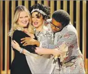  ?? Christophe­r Polk NBC ?? POEHLER embraces Maya Rudolph and Kenan Thompson during a skit by the “SNL” alums.