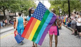  ?? STEVE SCHAEFER FOR THE AJC/2017 ?? Atlanta is home to an active and highly visible LGBTQ community, as evidenced by the annual Atlanta Pride Parade, which draws supporters to march down Peachtree Street with rainbow flags.