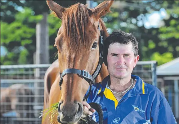  ?? Picture: HELEN ORR ?? Darwin trainer David Bates, enjoying the company of Enchanted Boy, has endured mixed fortunes during a distinguis­hed horse racing career
