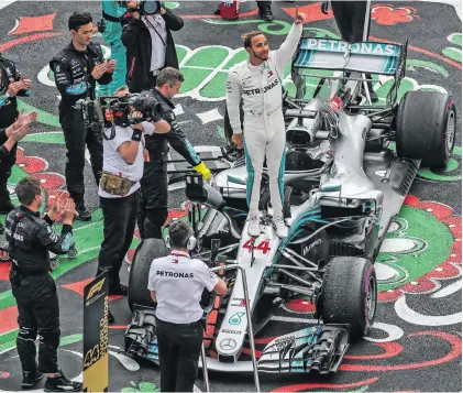  ?? Picture: Mercedes-Benz ?? UPSTANDING. Lewis Hamilton was emotional, and rightly so, after clinching his fifth Formula One world title last Sunday.