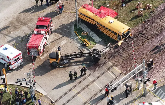  ?? SUN- TIMES FILE PHOTO ?? Metra train No. 624 crashed into a school bus on Oct. 25, 1995, at Algonquin Road and Northwest Highway in Fox River Grove. Seven teenagers died, and the bus driver and 24 passengers were hurt.