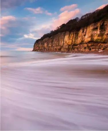  ?? ?? Soft sand is revealed at low tide on windswept and wave-beaten Pett Level Beach, at the foot of Fairlight Cliffs