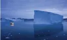  ?? Photograph: Felipe Dana/AP ?? A boat navigates a large iceberg in eastern Greenland.