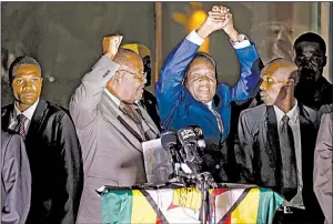  ??  ?? Emmerson Mnangagwa (center) greets cheering supporters Wednesday night in Harare after the ruling Zimbabwe African National Union-Patriotic Front party nominated him as interim president.