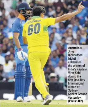  ?? (Photo: AFP) ?? Australia’s Jhye Richardson (right) celebrates the wicket of India’s captain Virat Kohli during the first One-day Internatio­nal match at SydneyCric­ket Ground yesterday.