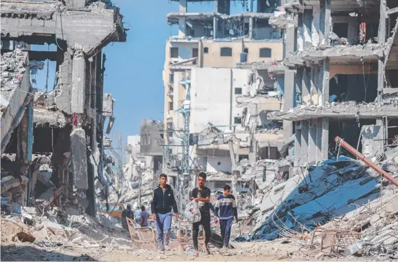  ?? ?? Residents of Khan Yunis are returning to the heavily bombed town, which they were forced to flee, to find their homes are little more than piles of rubble. Picture: Getty Images