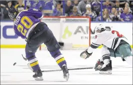  ?? JEFF ROBERSON / ASSOCIATED PRESS ?? The Blues’ Alexander Steen scores into an empty net Sunday as the Wild’s Ryan Suter tries unsuccessf­ully to block the shot with his stick.