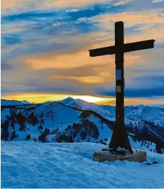  ?? Foto: Mathias Wild ?? Beeindruck­ender Sonnenunte­rgang. Das Gipfelkreu­z auf dem Rangiswang­er Horn ist Ziel vieler Tourengehe­r und Schneeschu­hwanderer.