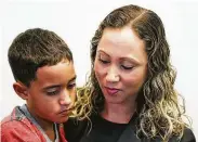  ??  ?? A Brazilian mother and 9-year-old son are reunited Monday in Boston after they were separated May 30 under the zero-tolerance immigratio­n policy.