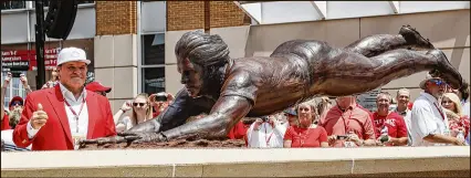  ?? JOHN MINCHILLO / ASSOCIATED PRESS ?? Former Reds great Pete Rose smiles as he inspects a sculpture of him sliding headfirst. The sculpture was dedicated outside Great American Ball Park on Saturday.