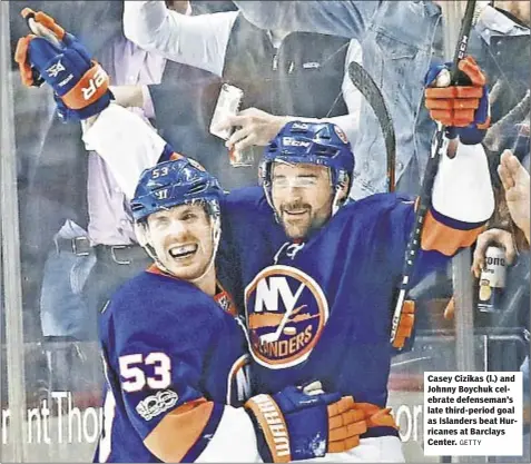  ?? GETTY ?? Casey Cizikas (l.) and Johnny Boychuk celebrate defenseman’s late third-period goal as Islanders beat Hurricanes at Barclays Center.