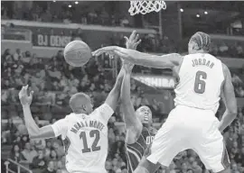  ?? Robert Gauthier Los Angeles Times ?? CLIPPERS CENTER DeAndre Jordan (6) blocks a shot by Orlando Magic guard Jodie Meeks in the second half as Luc Mbah a Moute gets into the act.