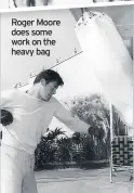  ??  ?? Roger Moore does some work on the heavy bag