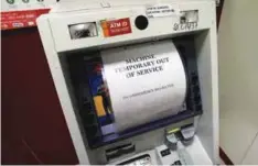 ??  ?? ... A notice is displayed on an ATM which is no longer dispensing cash in Chandigarh, India, yesterday, about a week after 500- rupee and 1,000-rupee notes were taken out of circulatio­n.